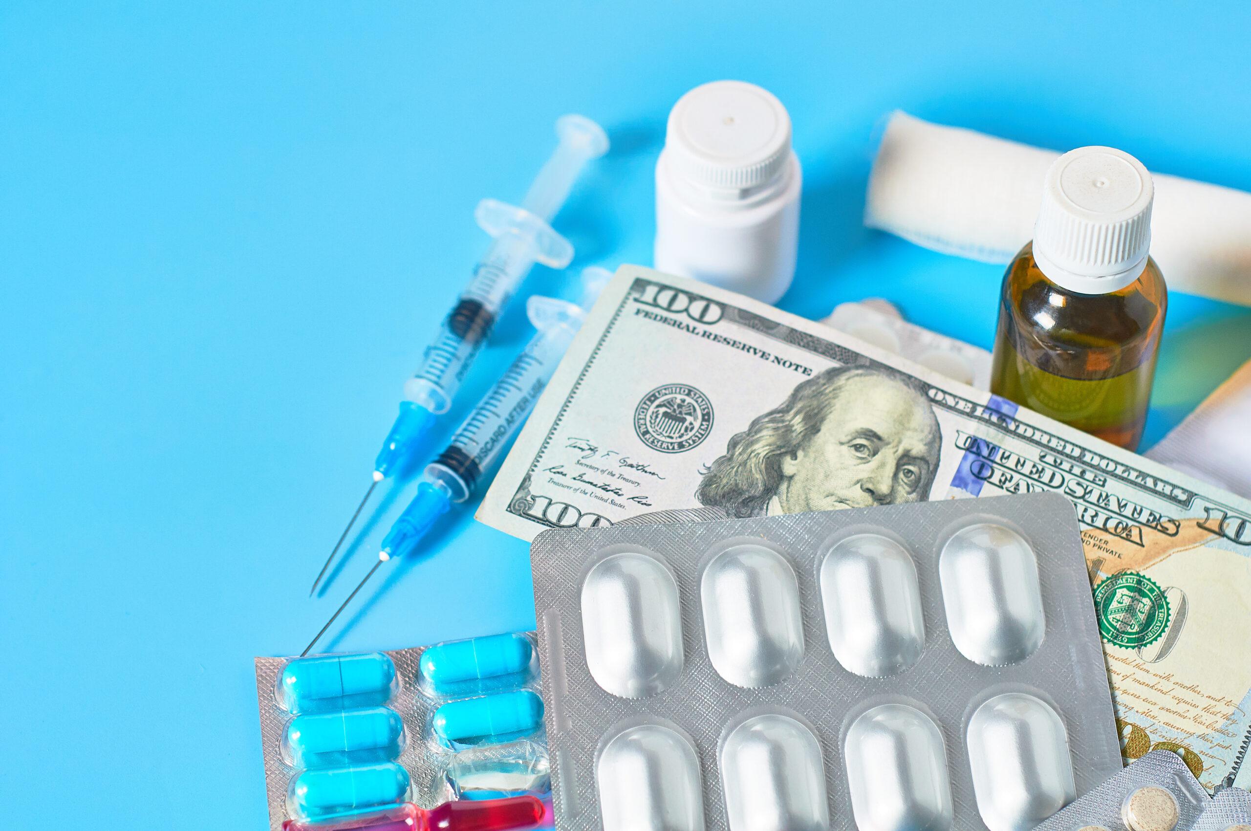 A one-hundred dollar bill with medications on a table.
