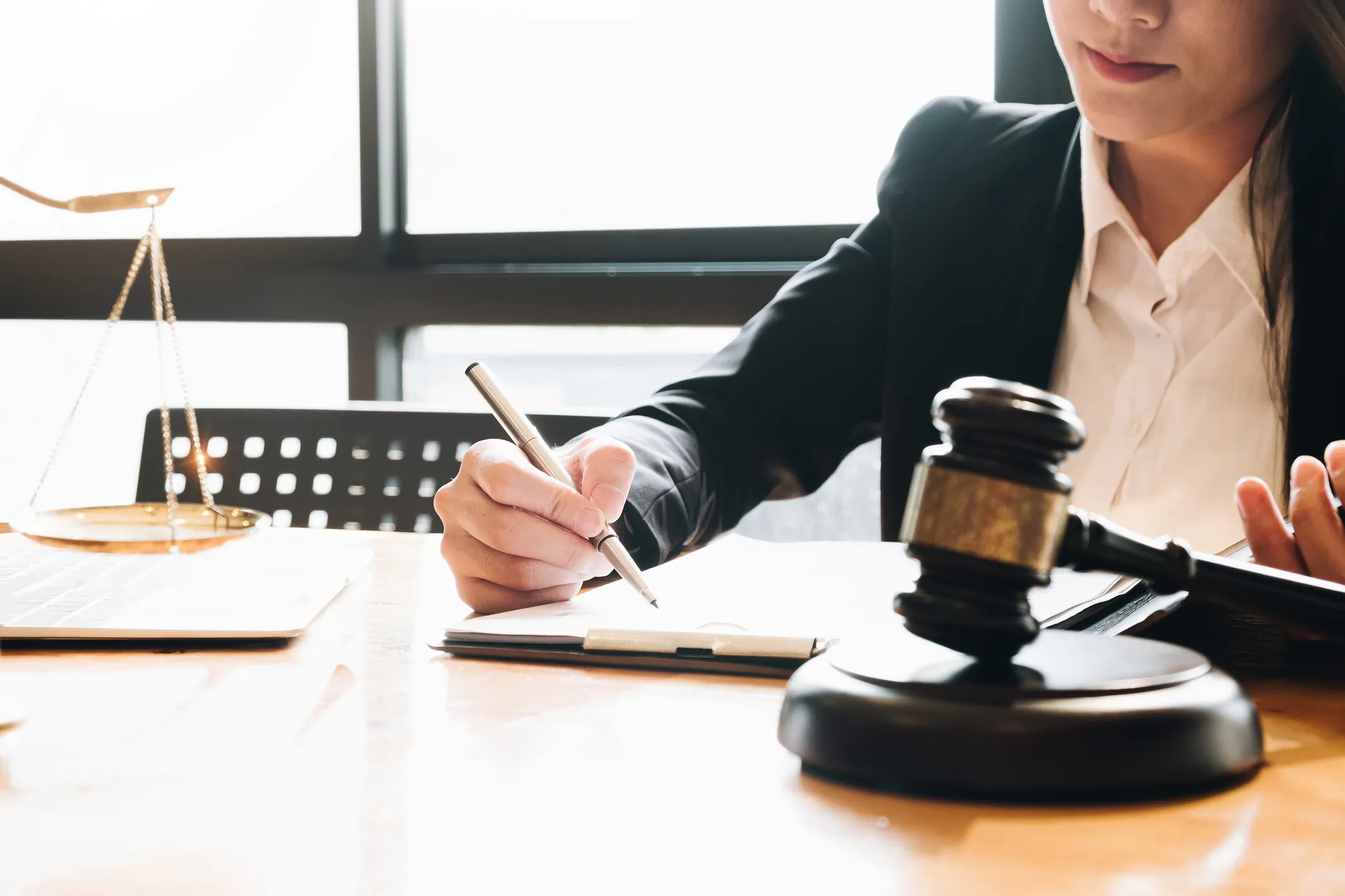 An attorney writing at her desk.