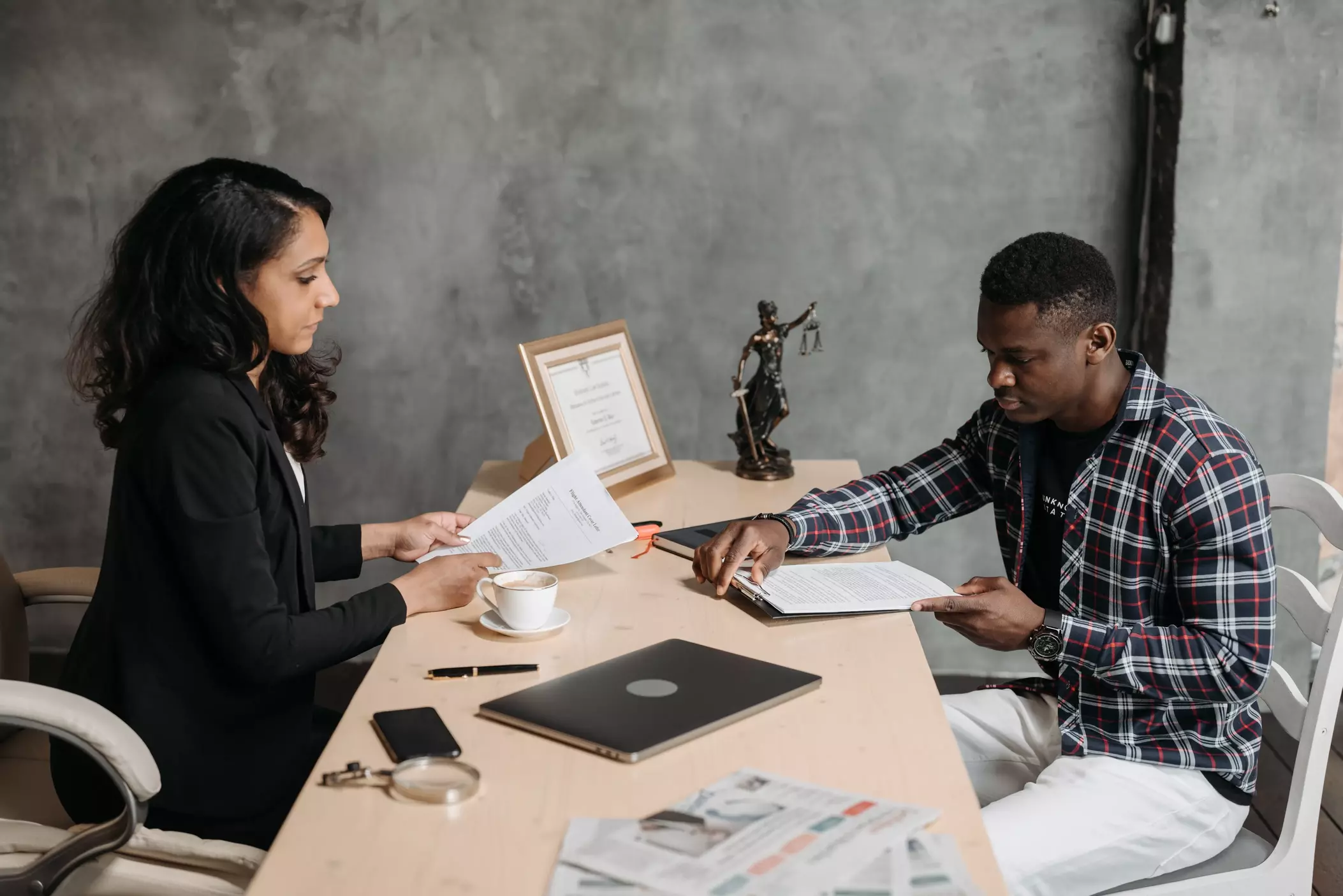 An attorney speaking with her client in her office.
