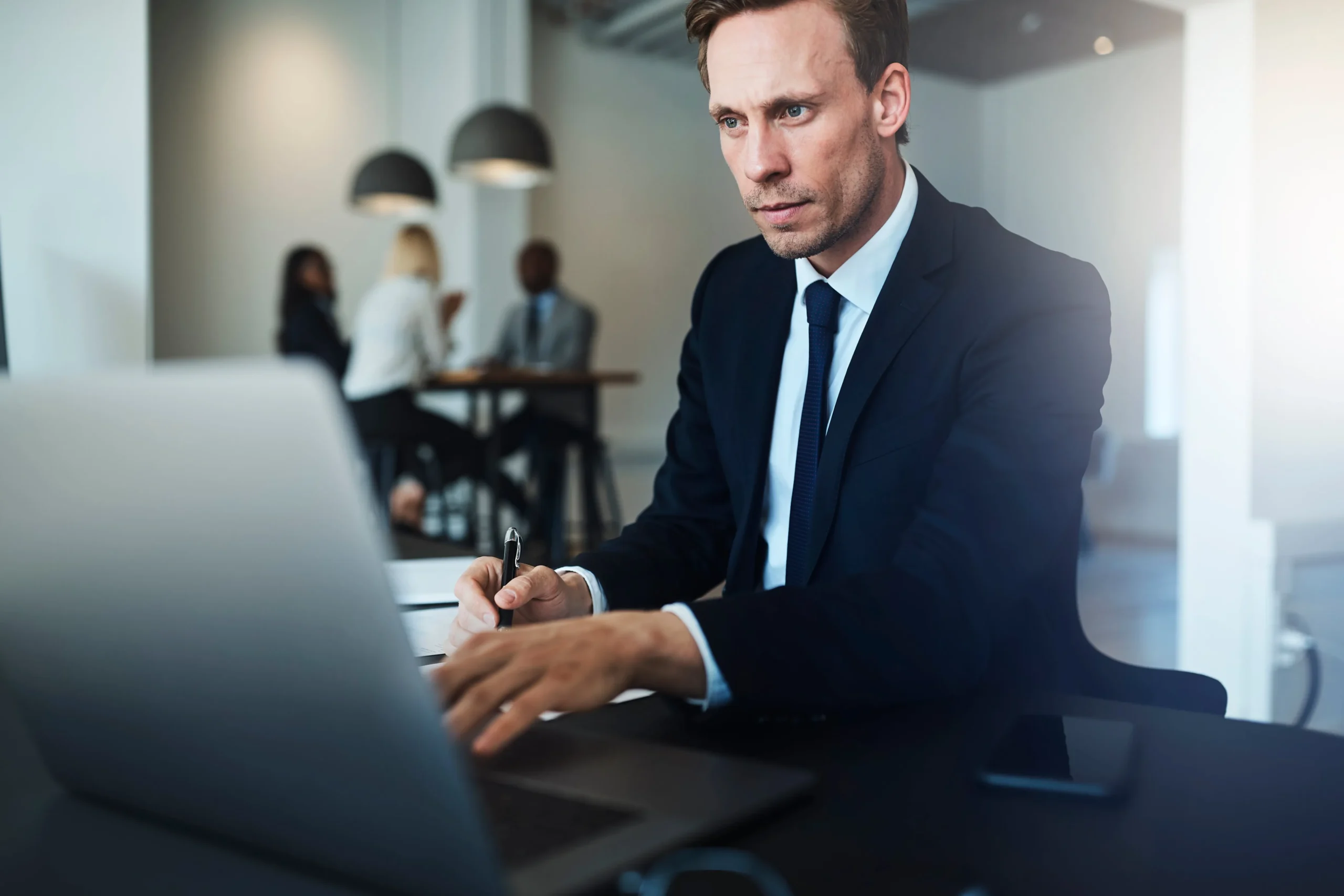 An attorney working at a desk on his computer.