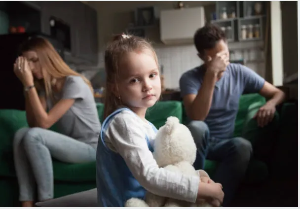 Upset parents behind a daughter.