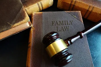 Book of Family Law with a gavel resting on top.