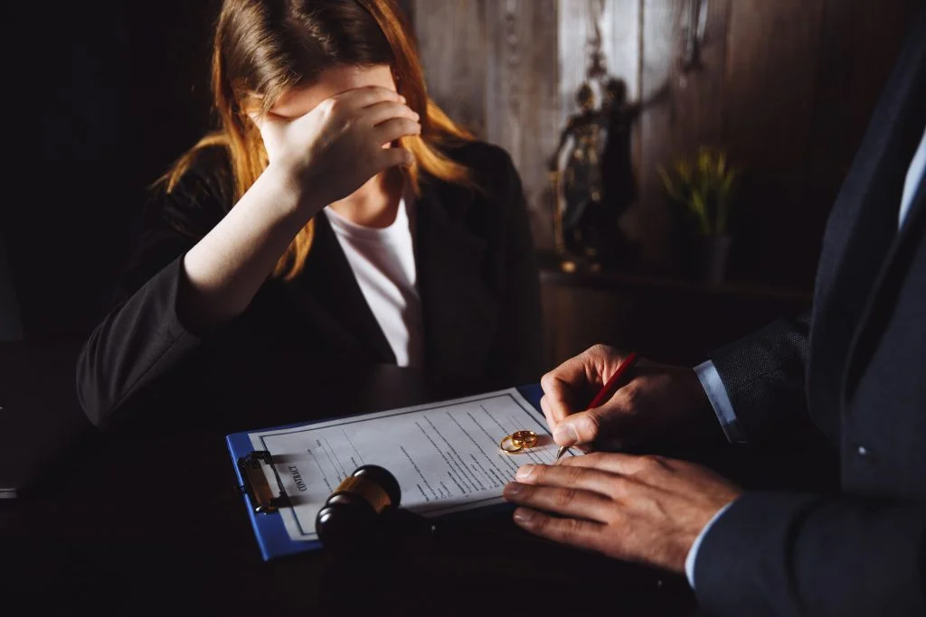 Attorney explaining a divorce document to a client in distress.