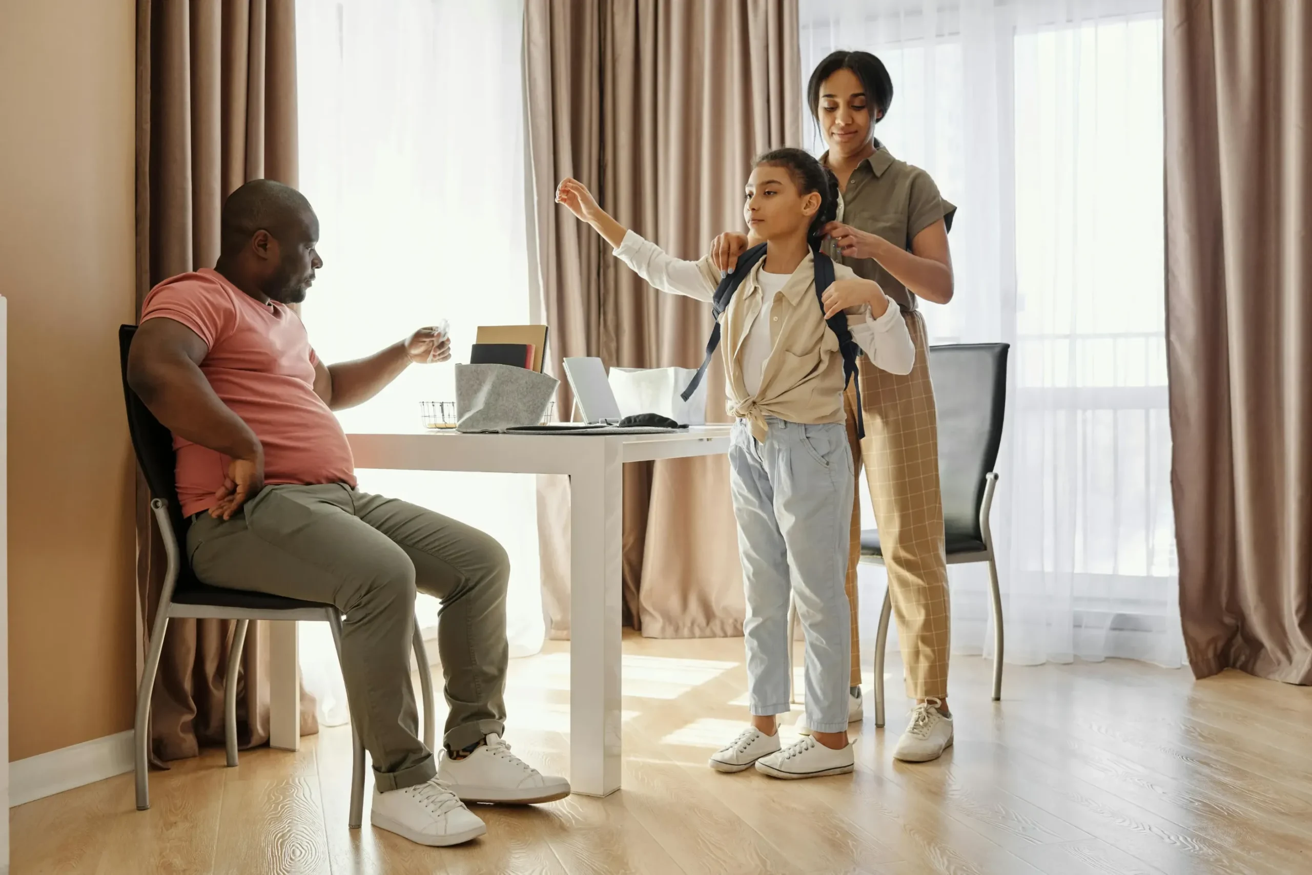 Parents getting their child ready for school.